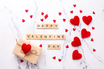 Romantic  layout. Box with present with hearts, wooden latters on  white marble background.  Place for text. Top view. St. Valentines day postcard.. - 556740737