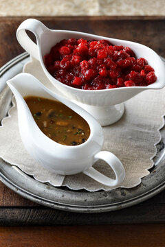 Two Gravy Boats filled with Mushroom Gravy and Cranberries for Thanksgiving Meal, Studio Shot