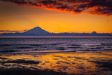 Sunset over Mount Redoubt and Aleutian Range, viewed across Cook Inlet, Kenai Peninsula, South-central Alaska in summertime; Ninilchik, Alaska, United States of America