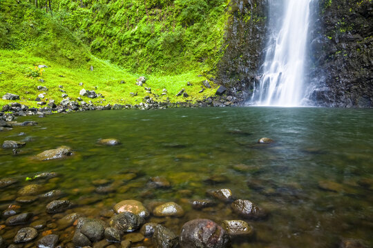 Close up of Hanakoa Falls and pool with lush green cliff, Na Pali Coast State Park; Kauai, Hawaii, United States of America