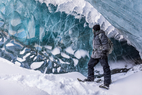 Fort Greely soldier observing the ice inside a cave on Canwell Glacier in the Delta Mountains of the Alaska Range; Alaska, United States of America