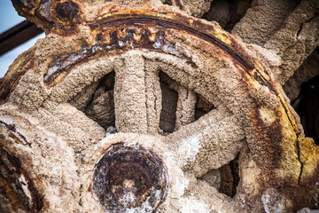 Exploring the eroding city of Bombay in Salton City, California. A crane erodes away on the beach; Bombay, California, United States of America