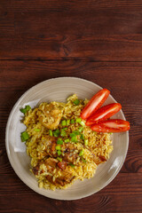 Fried chicken pieces in soy and pad thai sauce in a plate.