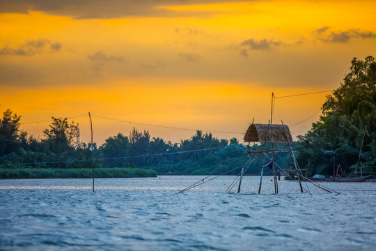 A fishing hut at sunset on the Thu Bon River; Hoi An, Quang Nam, Vietnam