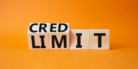 Credit and limit symbol. Turned wooden cubes with words credit and limit. Beautiful orange background. Business and Credit limit concept. Copy space