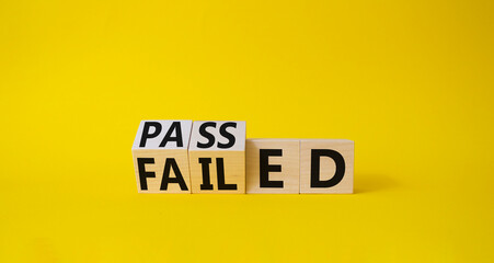Passed and Failed symbol. Turned wooden cubes and changes word Failed to Passed. Beautiful yellow background. Business and Passed and Failed concept. Copy space