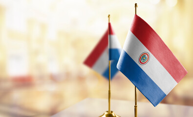Small flags of the Paraguay on an abstract blurry background