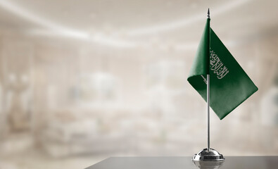 A small Saudi Arabia flag on an abstract blurry background