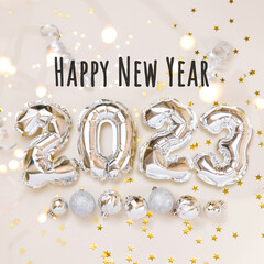 Happy New year 2023 balloo celebration. Silver foil balloons numeral 2023, party decoration and Happy New Year lettering on beige background. Flat lay, happy holidays cangratulation