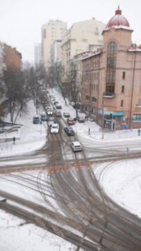 Panoramic view of a city street during snowfall. City life in winter