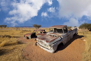 Abandoned car wrecks on the edge of desert Namib-Naukluft National Park in the Solitaire, Namibia 
