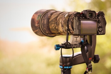 Digital camera with telephoto lens ready to capture wildlife - obrazy, fototapety, plakaty