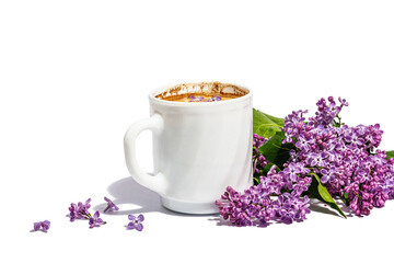 Cup of coffee and lilac flowers bouquet isolated on a white background. Breakfast springtime concept