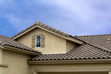 Tiled roof and attic window of a single-family residence, Oasis Community, Menifee, California, USA