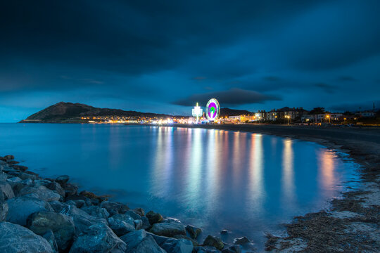 The carnival fun rides lit up at night in Bray, County Wicklow, Ireland.