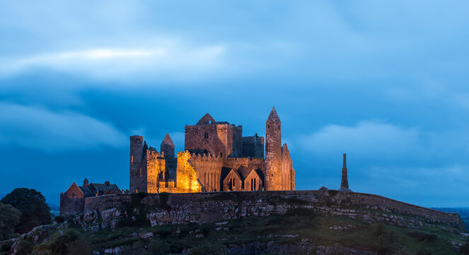 The ancient Rock of Cashel illuminated at dusk; Cashel, County Tipperary, Ireland