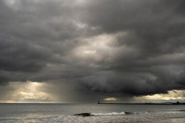 Threatening storm clouds over the ocean and coastline; Sunderland, Tyne and Wear, England