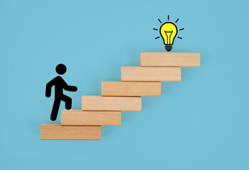 Stickman climbing steps towards a light bulb. Concept of success Growth and development,...
