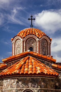 Close-up of the ornate clay tiled central dome and stone exterior of The Chapel of St Nicholas at St Anthony's Greek Orthodox Monastery; Florence, Arizona, United States of America