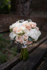 The bride's bouquet of pink peonies on dark backround.