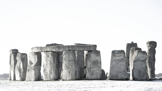 Black and white image of Stonehenge defined by early morning snow; Wiltshire, England