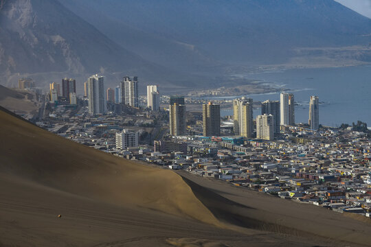 South part of the port city of Iquique with skyline and Cerro Dragon (Dragon Hill) the large, urban sand dune that overlooks the city; Iquique, Tarapaca, Chile