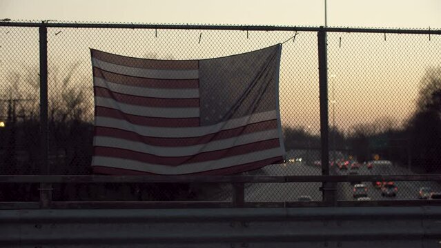 American Flag Waving Above U.S. Interstate 95 at Night