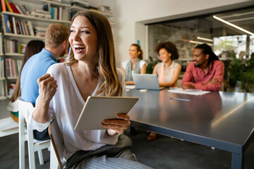 Smiling diverse colleagues gather in boardroom brainstorm discuss financial statistics together