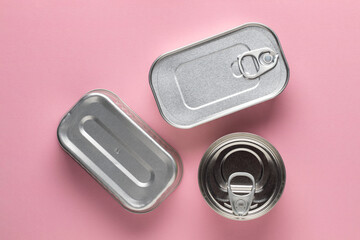 Canned food, top view. On pink background.