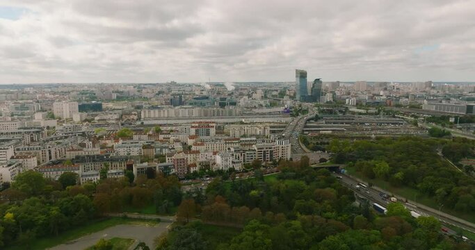 Aerial view of the suburbs of a major capital. Parisian high buildings of the business district with flowering plants on the balconies. Paris from a bird's eye view. Urban landscaping in big cities