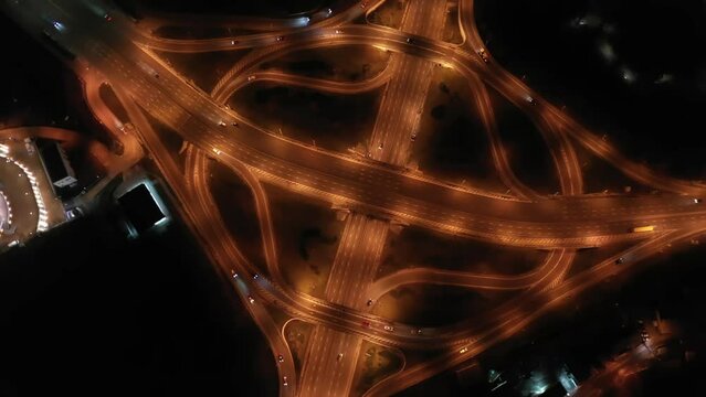 Paton Bridge in Kyiv at night, Ukraine. Aerial view. Car traffic on bridge. Circular movement of cars. Night. 