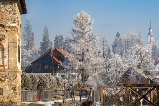 Village and Lazar Castle in hoar frost of winter, rural Harghita County, Transylvania, Romania; Harghita, Transylvania, Romania