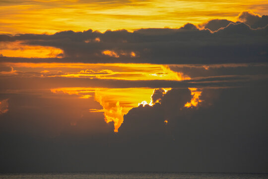 Tropical sunset with dramatic cloud formations off the coast of Morobe Province; Marobe, Papua New Guinea
