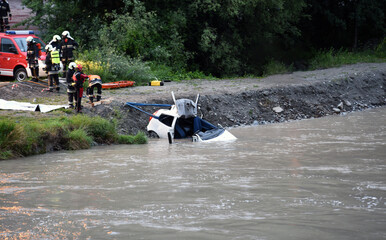 Firefighters and divers recover a driver's car that ended up in a lake or river after a terrible...