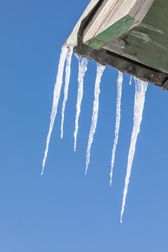 Detail photograph of icicles hanging from the eave of Our Lady of the Snows Catholic Mission Building on a sunny day in winter; Nulato, Interior Alaska, Alaska, United States of America