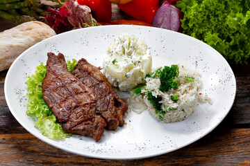 Beef steak with potatoes and rice in isolated white background