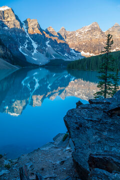 Valley of the Ten Peaks reflected in the tranquil water of Moraine Lake under a bright blue sky in Banff National Park; Alberta, Canada