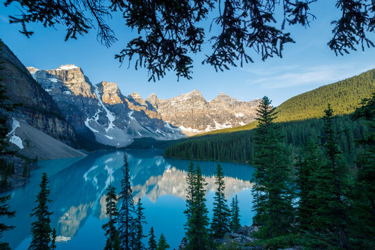 Valley of the Ten Peaks reflected in the tranquil water of Moraine Lake under a bright blue sky in Banff National Park; Alberta, Canada