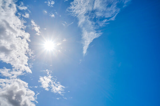 Sunburst In A Bright Blue Sky With Light Clouds; Hirtshals, Jutland, Germany