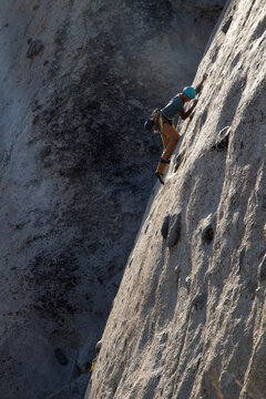 A climber balances up a tricky slab in Whitney Portal.