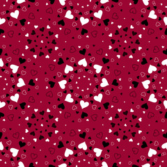 Seamless pattern with white and black hearts on a red background.