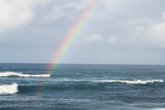 A rainbow over stormy water off Hookipa beach.