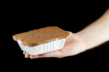 Liver pate in a container in hand