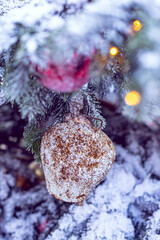 Christmas tree decorated with vintage bells and balls on a blurred abstract sparkling background