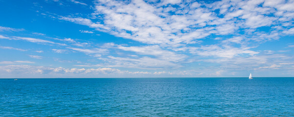 A lone sailboat on the blue waters of Lake Ontario; Niagara-on-the-Lake, Ontario, Canada