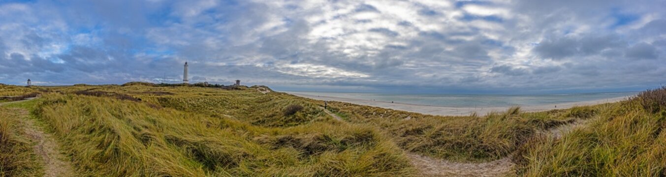 Panoramic picture over the beach and lighthouse of the Danish coastal town Balavand during the day