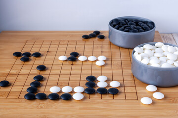 dice laid out on a goban, a game of Go
