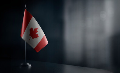Small national flag of the Canada on a black background