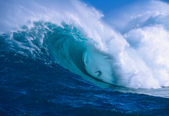 Professional surfer, Garrett McNamara, surfing in the barrel at Jaws (also known as Peahi) on the North Shore of Maui; Maui, Hawaii, United States of America