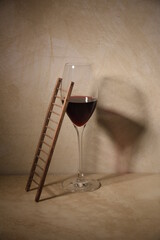 ladder against glass of red wine